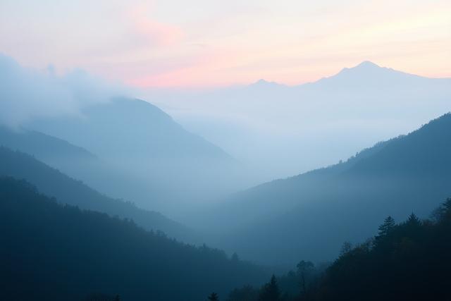 A misty morning landscape of mountains and clouds